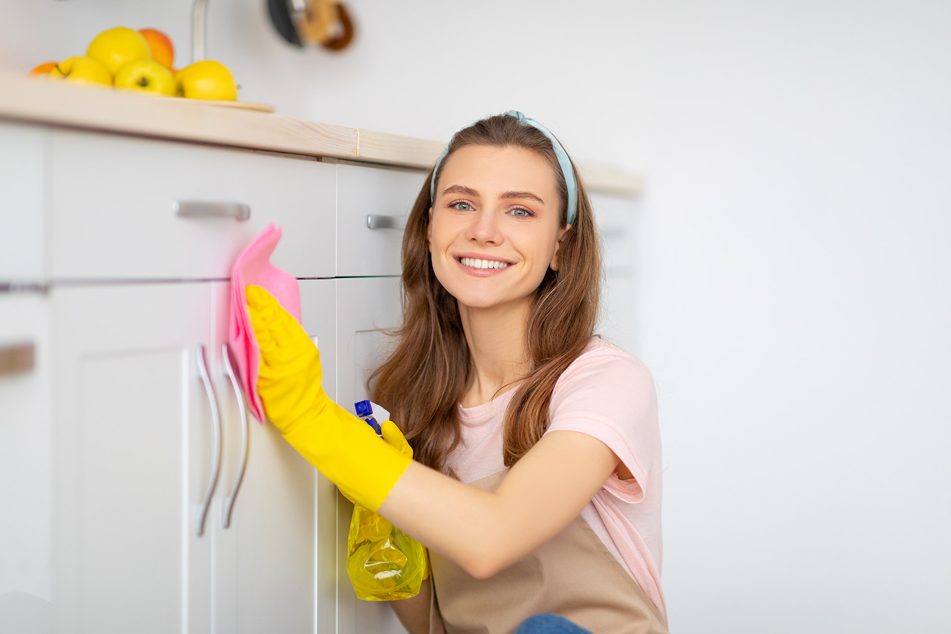 positive-young-lady-washing-kitchen-cabinet-with-d-2021-09-02-05-06-11-utc.jpg